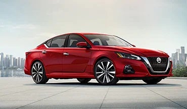 2023 Nissan Altima in red with city in background illustrating last year's 2022 model in Bob Allen Nissan in Danville KY